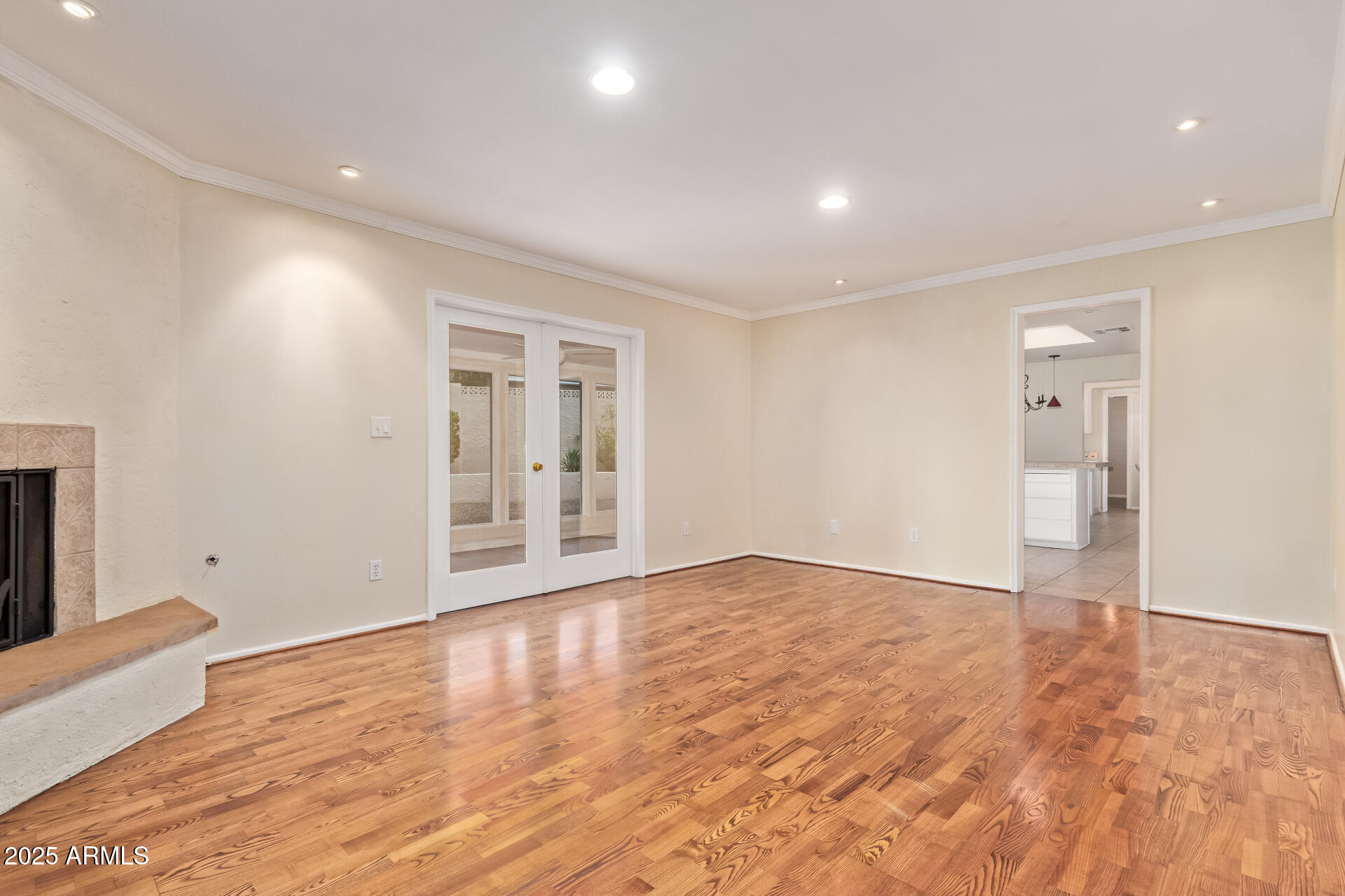 2234 East Lawrence Road Phoenix, AZ 85016 - Photo 13 of 71 a view of an empty room with wooden floor and a window