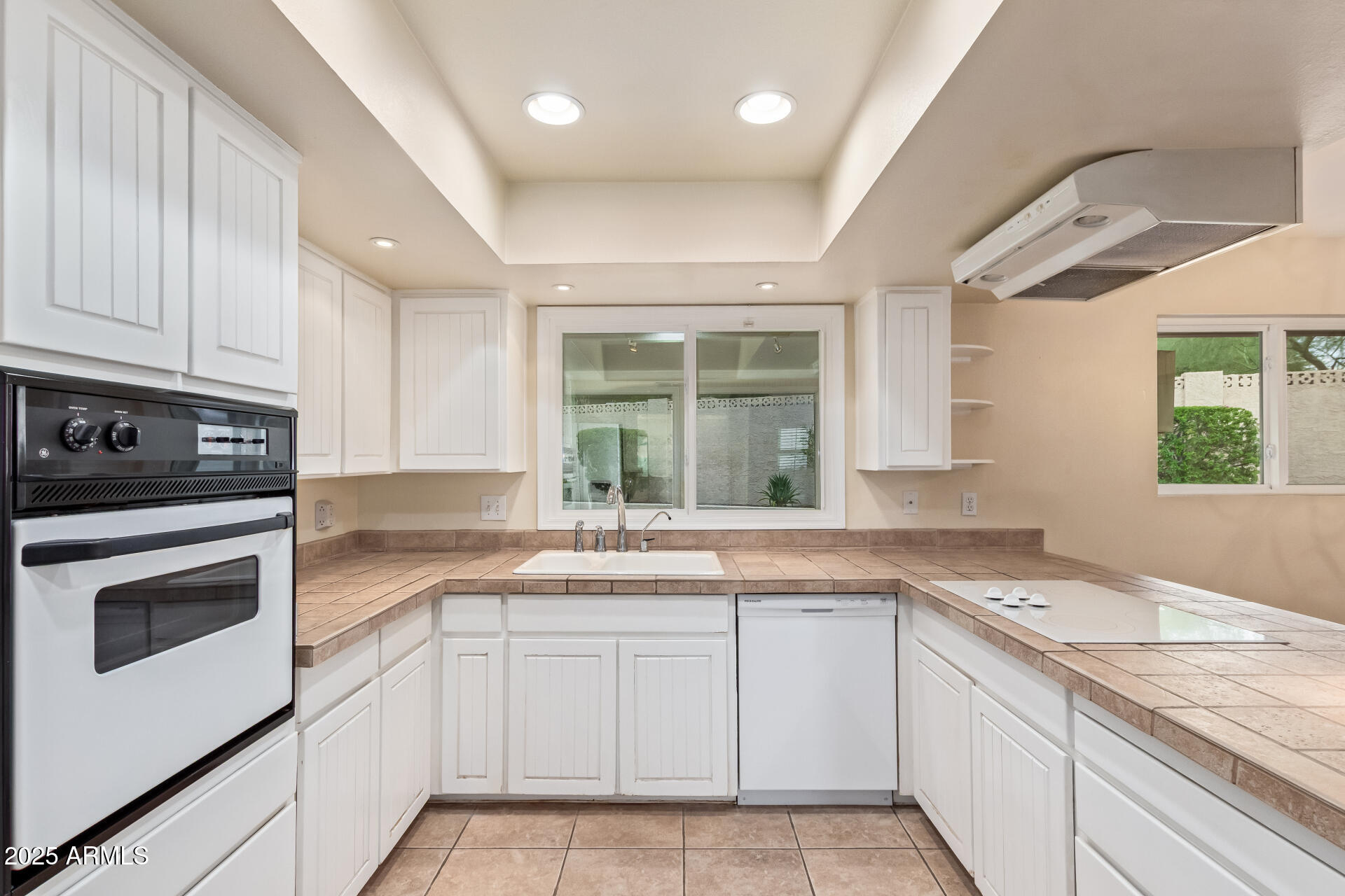 2234 East Lawrence Road Phoenix, AZ 85016 - Photo 15 of 71 a kitchen with granite countertop stainless steel appliances white cabinets and a window