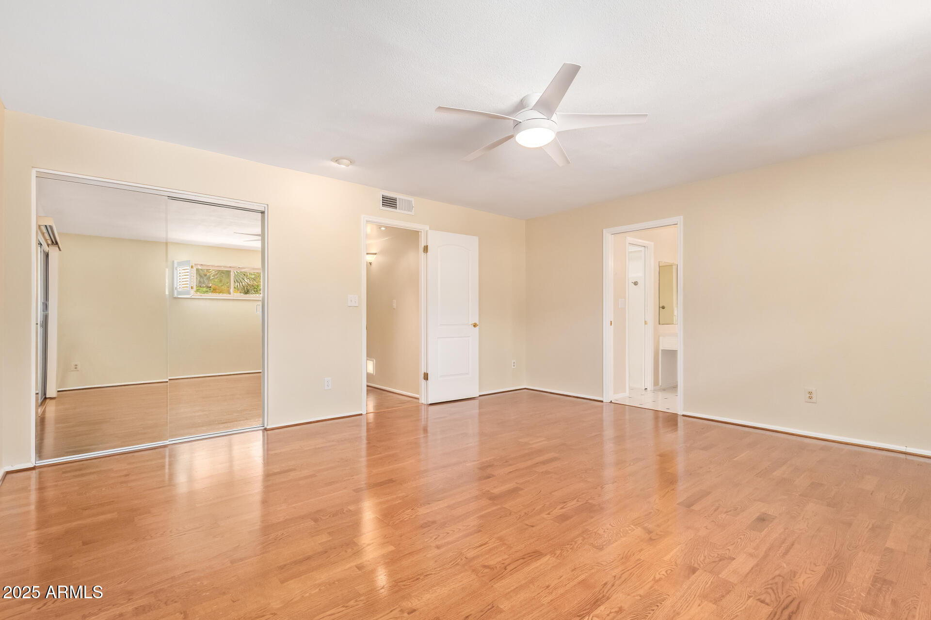 2234 East Lawrence Road Phoenix, AZ 85016 - Photo 23 of 71 an empty space with wooden floor and a bathroom
