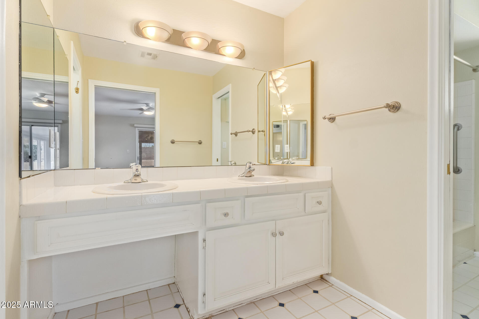 2234 East Lawrence Road Phoenix, AZ 85016 - Photo 25 of 71 a bathroom with a double vanity sink and mirror