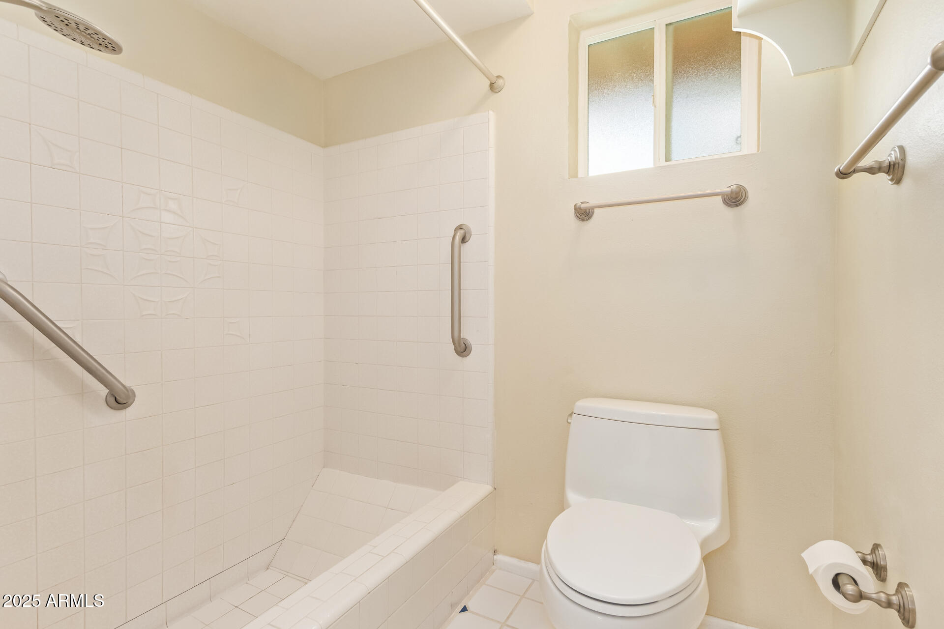 2234 East Lawrence Road Phoenix, AZ 85016 - Photo 26 of 71 a white toilet sitting next to a bath tub and a shower