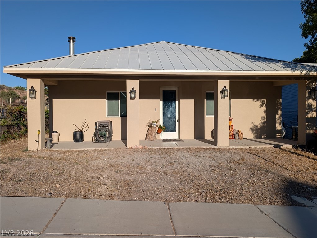 This residence features a welcoming front porch, perfect for enjoying the outdoors.