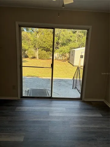 a view of a house with a yard and sitting area