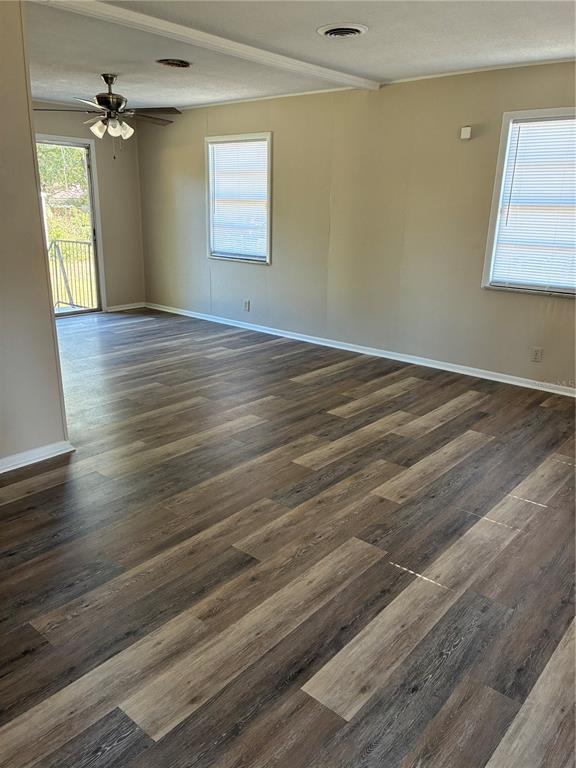 470 Southwest Dove Street Keystone Heights, FL 32656 - Photo 3 of 20 an empty room with wooden floor and windows