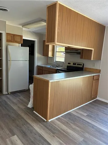 a kitchen with stainless steel appliances a refrigerator and a stove