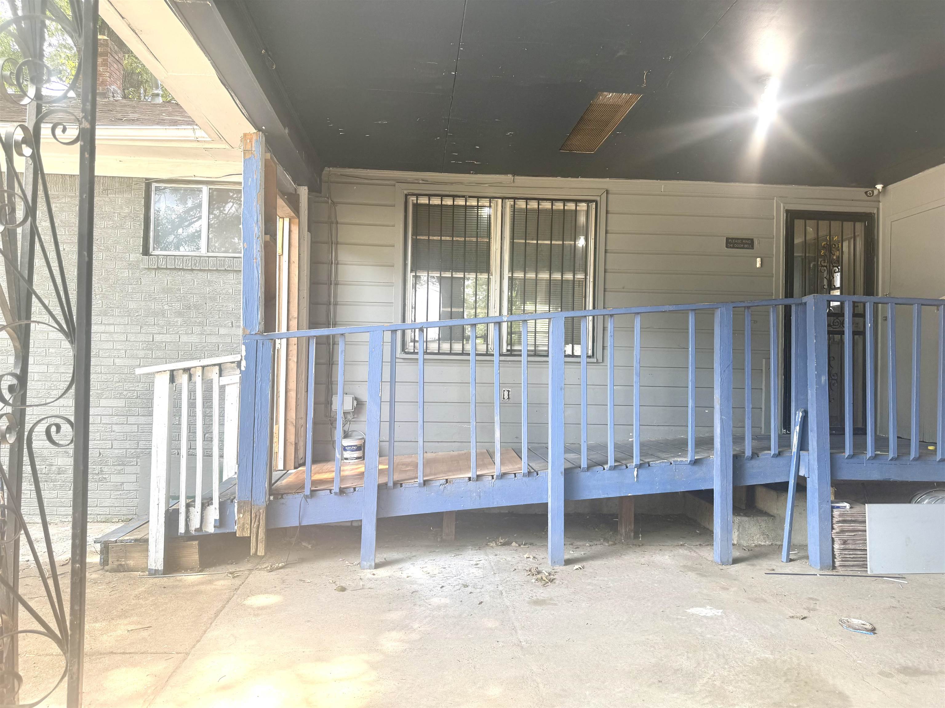 2930 Getwell Road Memphis, TN 38118 - Photo 21 of 25 Exterior featuring a covered porch with a ramp entry, grey horizontal siding, and a security screen door