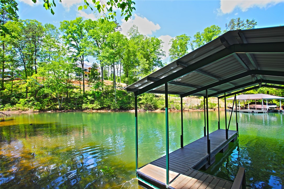 Lot 114 Harbor Point Seneca, SC 29672 - Photo 27 of 46 This serene lakefront property includes a private covered dock, offering tranquil water access and scenic views.