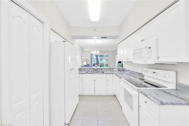 a kitchen with appliances cabinets and a sink