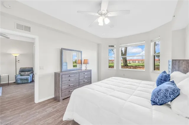 a bedroom with a bed and a ceiling fan