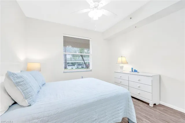 a bedroom with a bed and a lamp