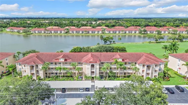 an aerial view of residential houses with outdoor space and river view