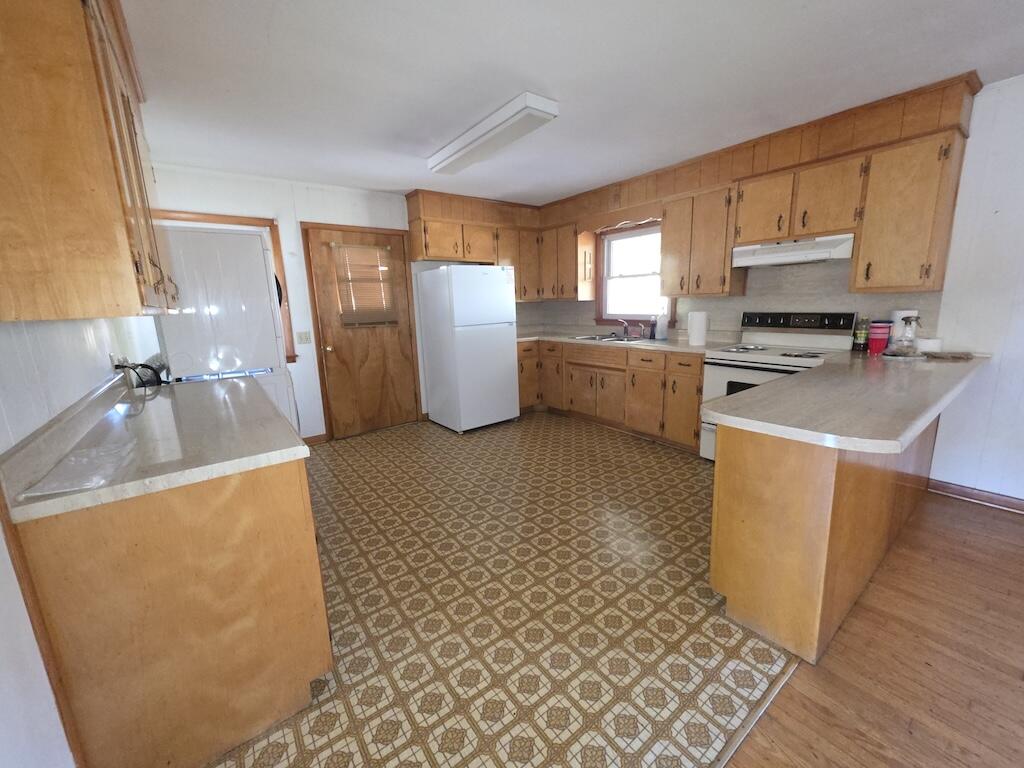 540 Bernard Road Rocky Mount, VA 24151 - Photo 11 of 23 a kitchen with a sink a stove top oven a refrigerator cabinets and a dining table