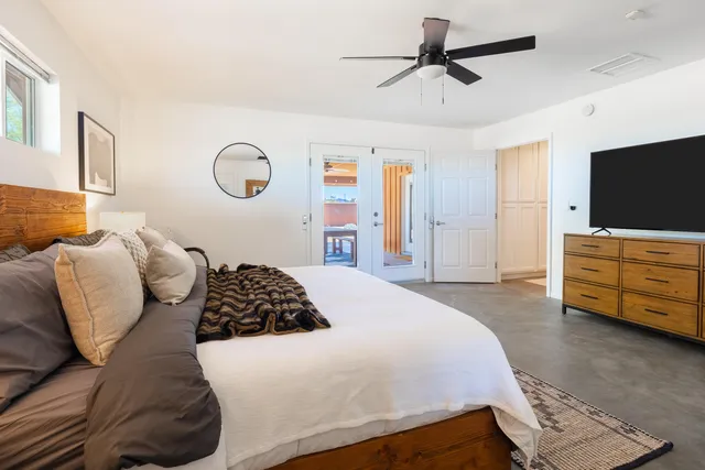 a bedroom with a bed and a chandelier