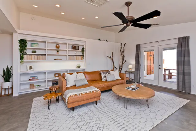 a living room with furniture and a large window