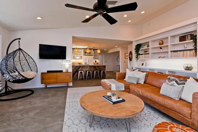 a spacious bedroom with a bed a couch and a dresser