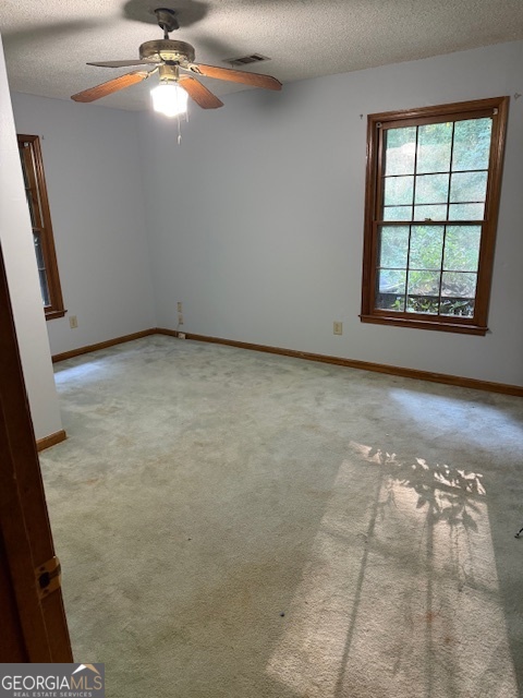 4112 Jodeco Road Stockbridge, GA 30281 - Photo 12 of 13 en empty room with windows and chandelier fan
