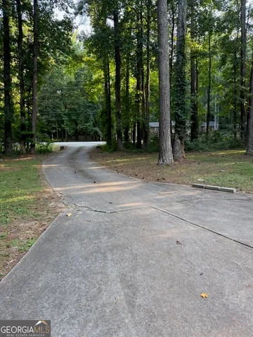 a view of a field with trees in the background