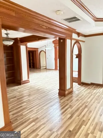 a view of entryway and hall with wooden floor