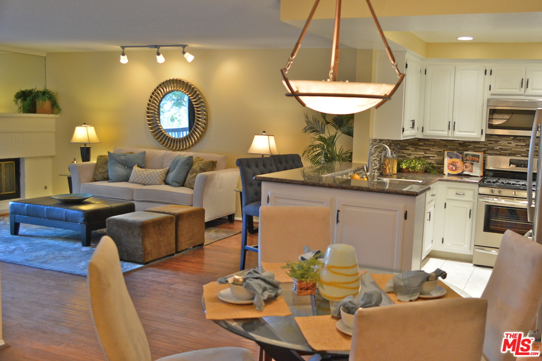 8515 Falmouth Avenue, Unit 322 Playa del Rey, CA 90293 - Photo 1 of 1 a living room with furniture and a chandelier