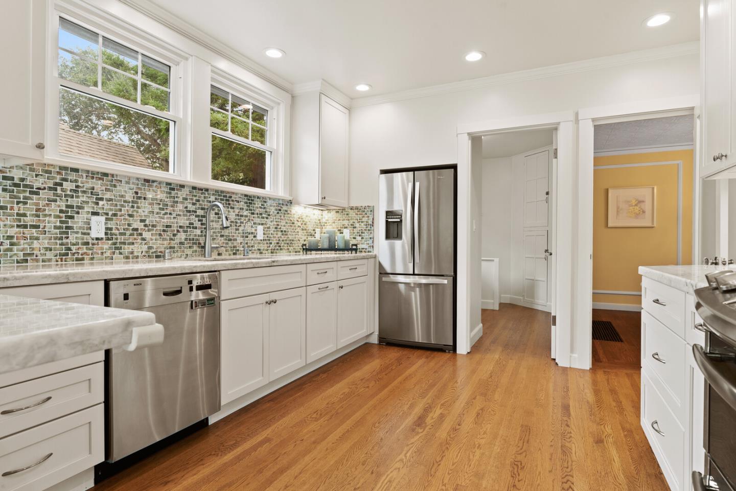 750 Edgewood Road San Mateo, CA 94402 - Photo 11 of 26 a kitchen with white cabinets and wooden floor