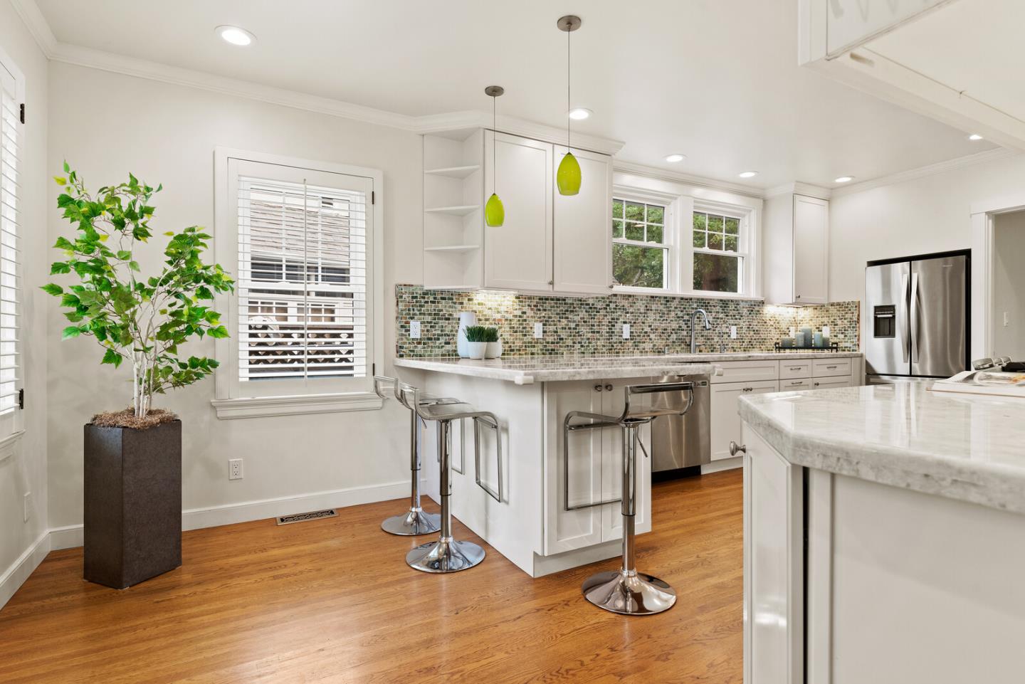 750 Edgewood Road San Mateo, CA 94402 - Photo 10 of 26 a kitchen with kitchen island granite countertop a table and chairs in it