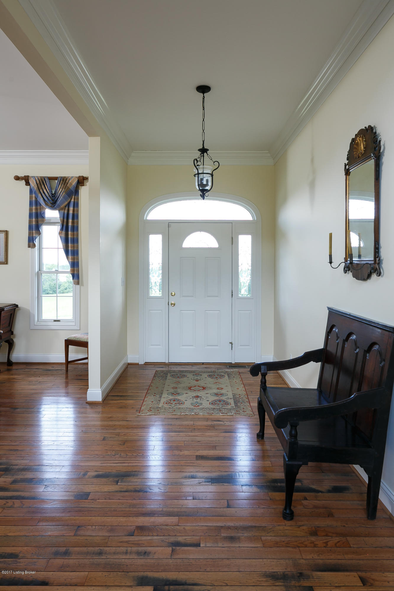 Hallway with beautiful hardwood floors throughout.