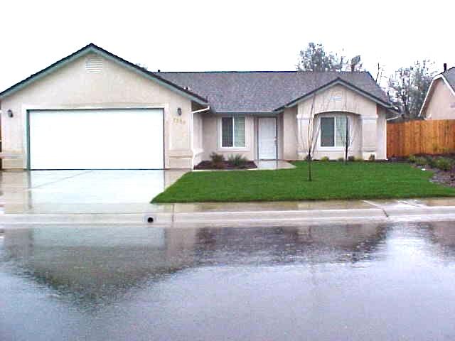 7518 Pit Road Redding, CA 96001 - Photo 1 of 1 a front view of a house with a yard and garage
