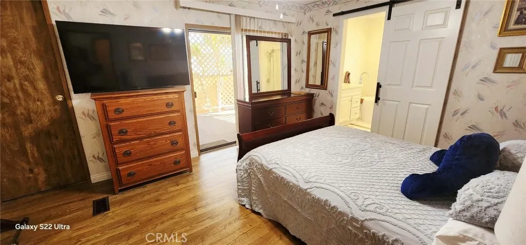 8651 Foothill, Unit 159 Rancho Cucamonga, CA 91730 - Photo 13 of 18 a bedroom with a bed closet and flat tv screen