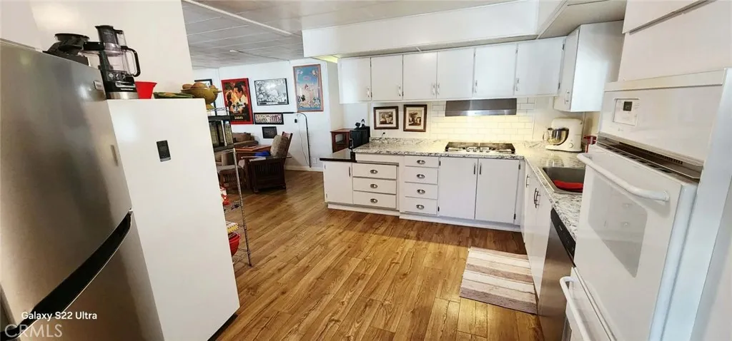 8651 Foothill, Unit 159 Rancho Cucamonga, CA 91730 - Photo 2 of 18 a room with white cabinets and appliances