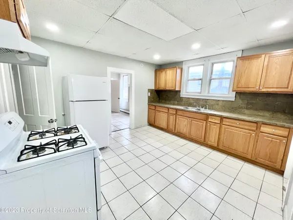 a kitchen with sink cabinets and stove