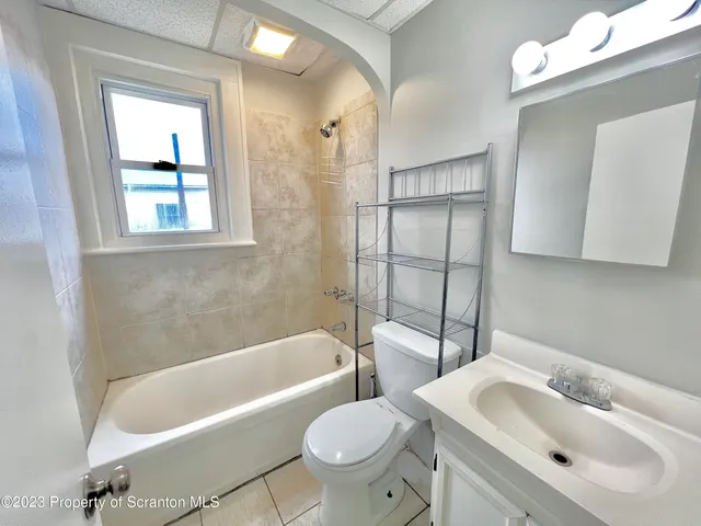 a bathroom with a sink toilet and bathtub