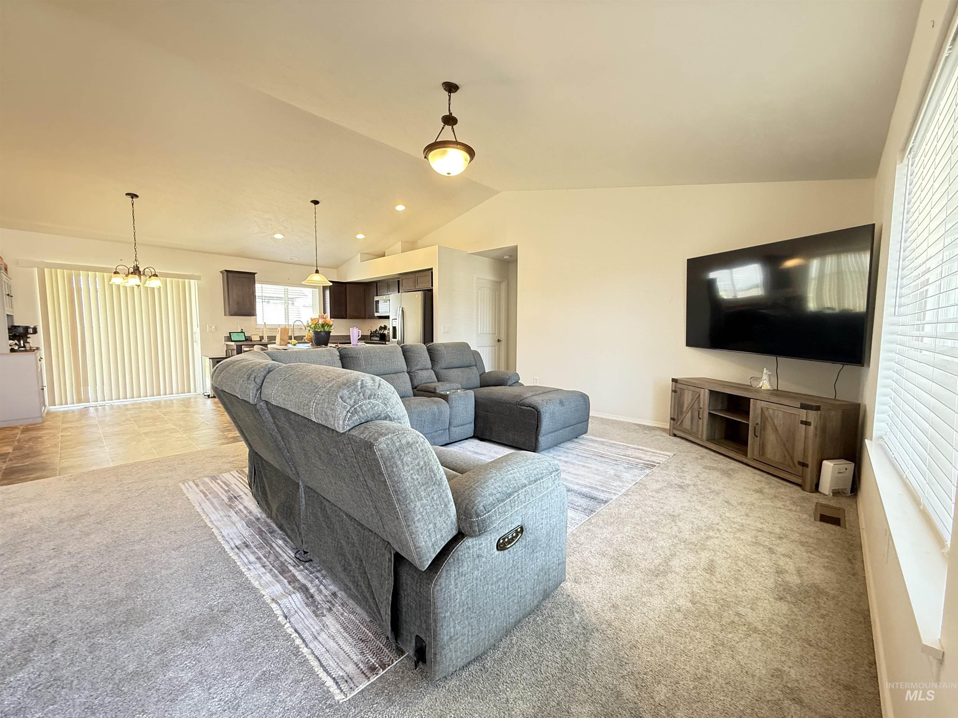 1556 Frontier Drive Lewiston, ID 83501 - Photo 7 of 23 Vaulted ceilings define this open-concept living space, featuring recessed lighting and two pendant fixtures