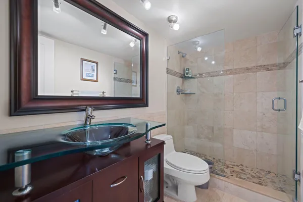 a bathroom with a sink toilet and shower