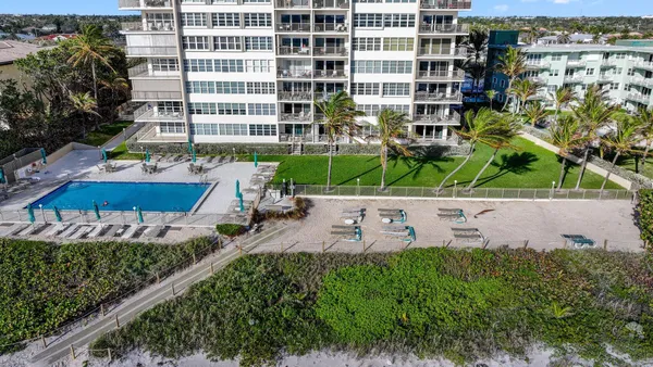 a view of a swimming pool with outdoor seating