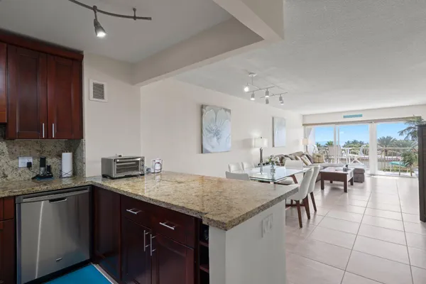 a kitchen with a table chairs and cabinets