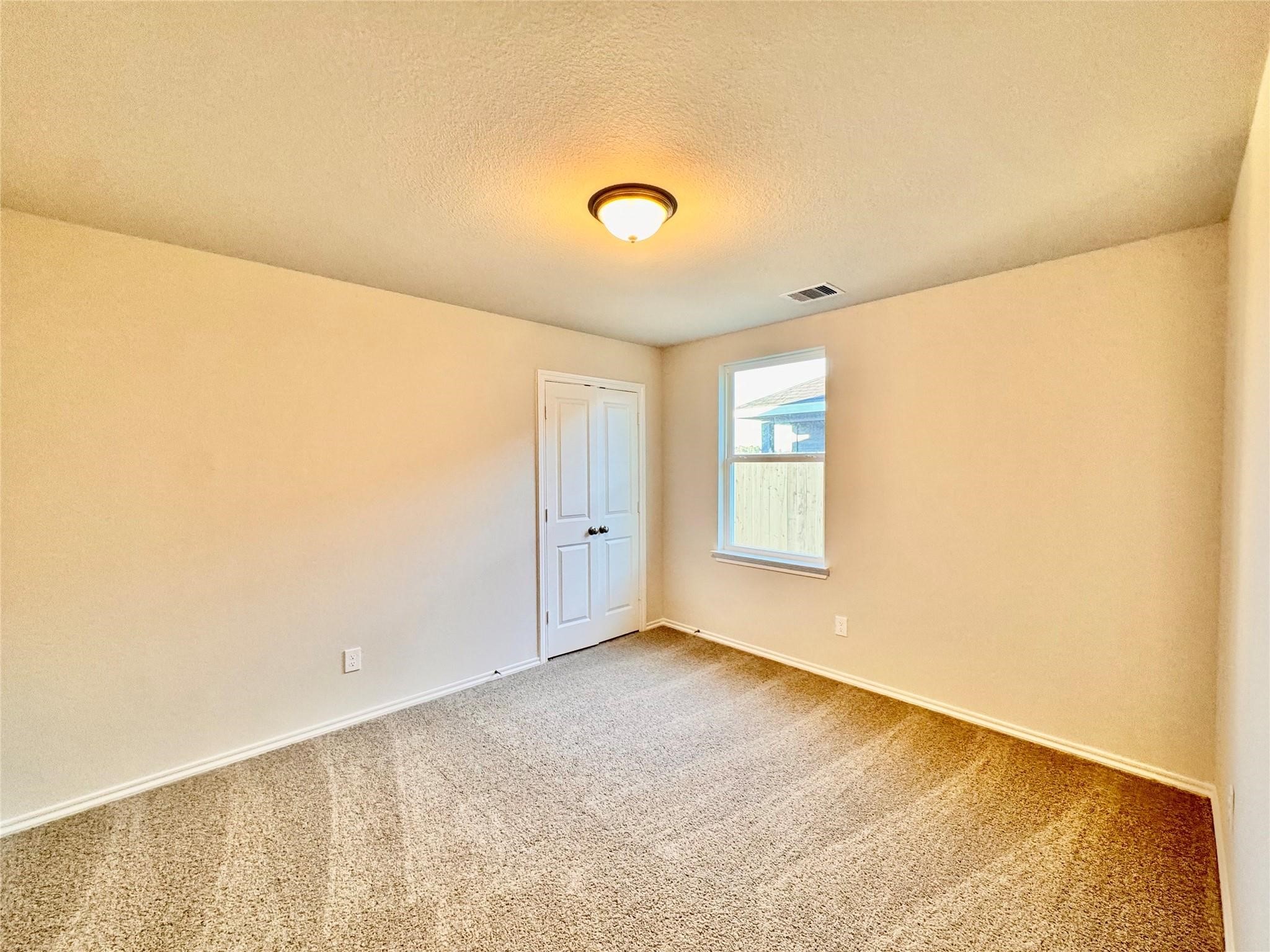 25786 John Wayne Court Splendora, TX 77372 - Photo 11 of 17 a view of an empty room with windows