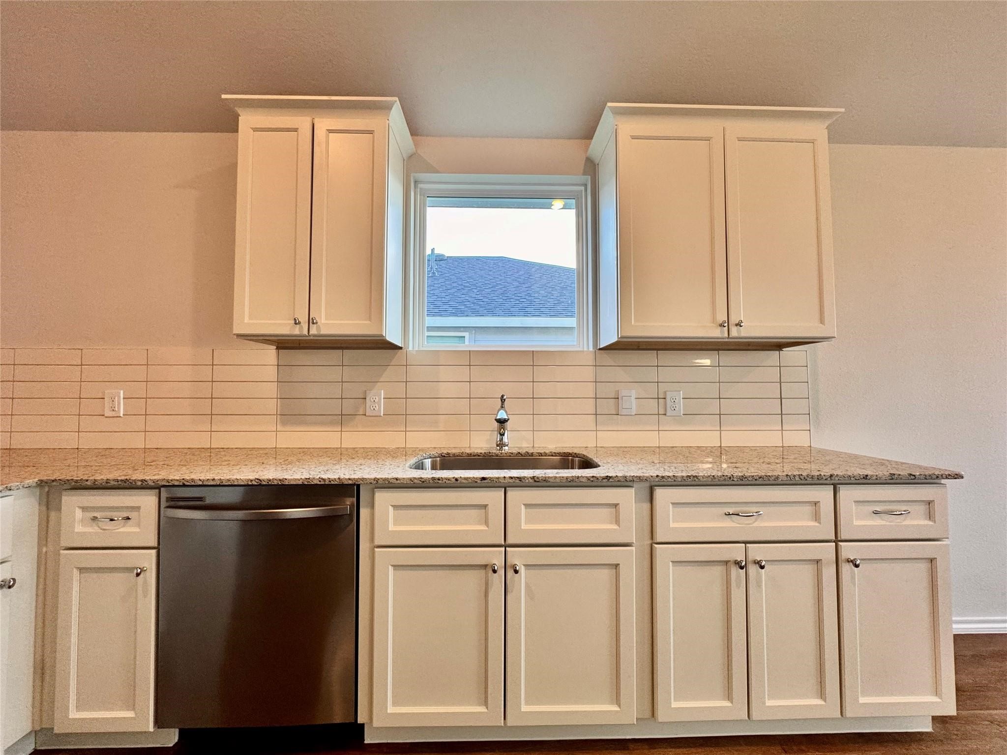 25786 John Wayne Court Splendora, TX 77372 - Photo 7 of 17 a kitchen with white cabinets and sink