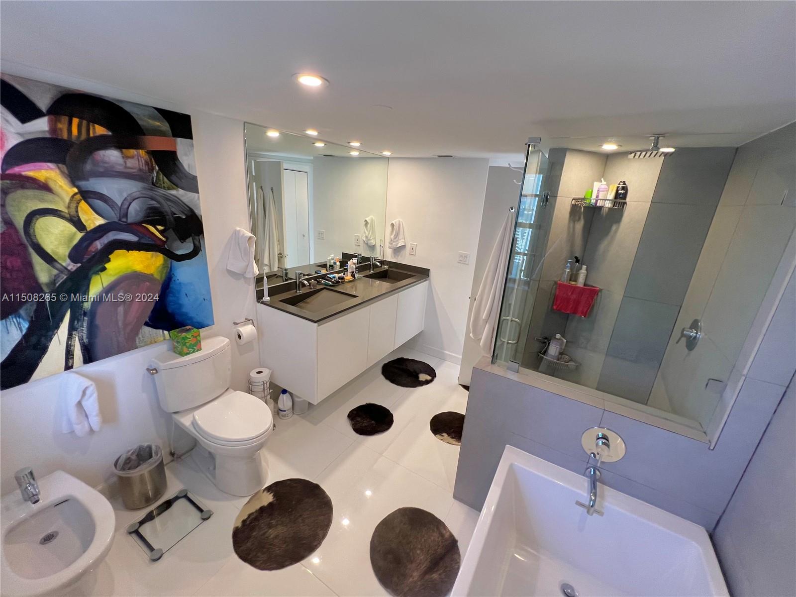 151 Southeast 15th Road, Unit 2401 Miami, FL 33129 - Photo 41 of 45 a bathroom with a sink mirror and toilet