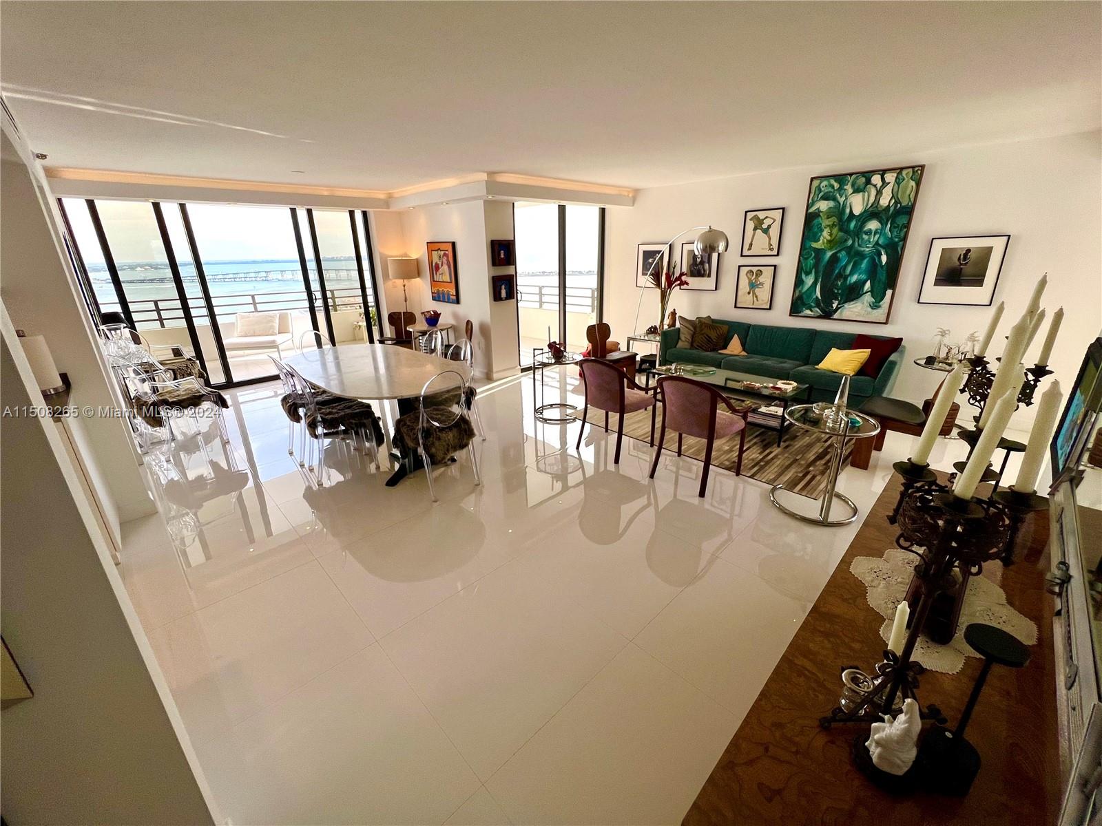 151 Southeast 15th Road, Unit 2401 Miami, FL 33129 - Photo 8 of 45 a living room with furniture and a large window