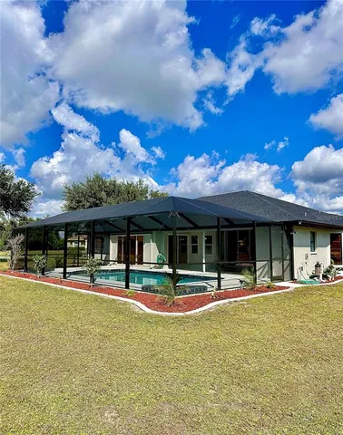 a front view of a house with a big yard