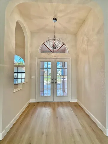 a view of a room with wooden floor fan and window