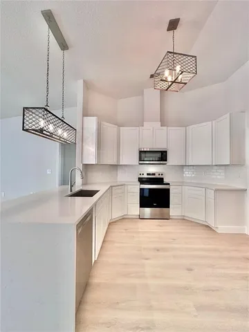 a kitchen with a refrigerator and a sink