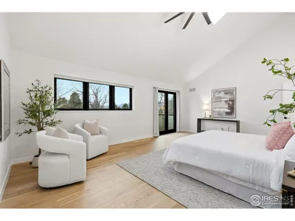 a bedroom with a large bed and a couch