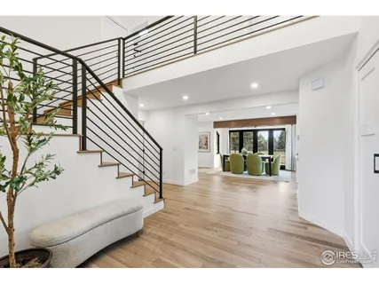 a view of entryway and hall with wooden floor