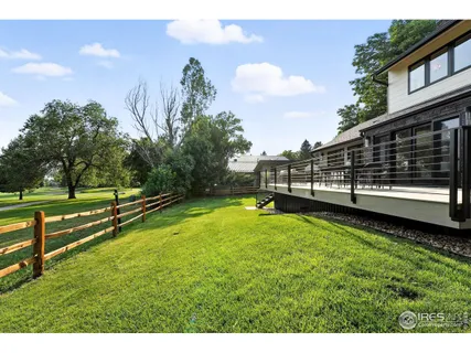 a view of a house with a swimming pool and a yard