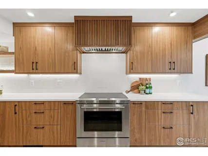 a kitchen with a stove and cabinets