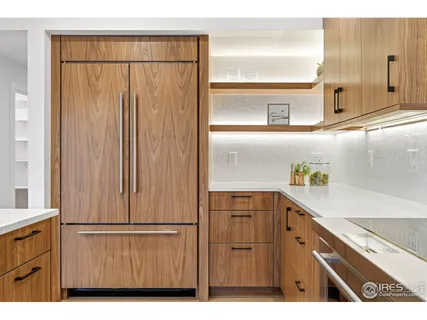a kitchen with a refrigerator and a sink