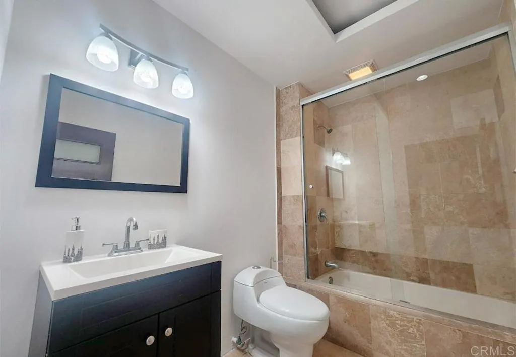 167 Marina San Diego Real De San Marino Ensenada Mex San Diego, CA 92101 - Photo 12 of 21 a bath room with a toilet a sink and a mirror