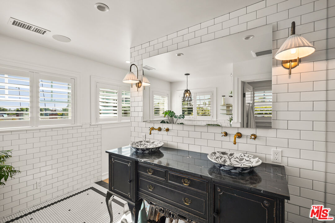 1240 Appleton Way Venice, CA 90291 - Photo 26 of 71 a bathroom with a granite countertop sink a toilet and mirror
