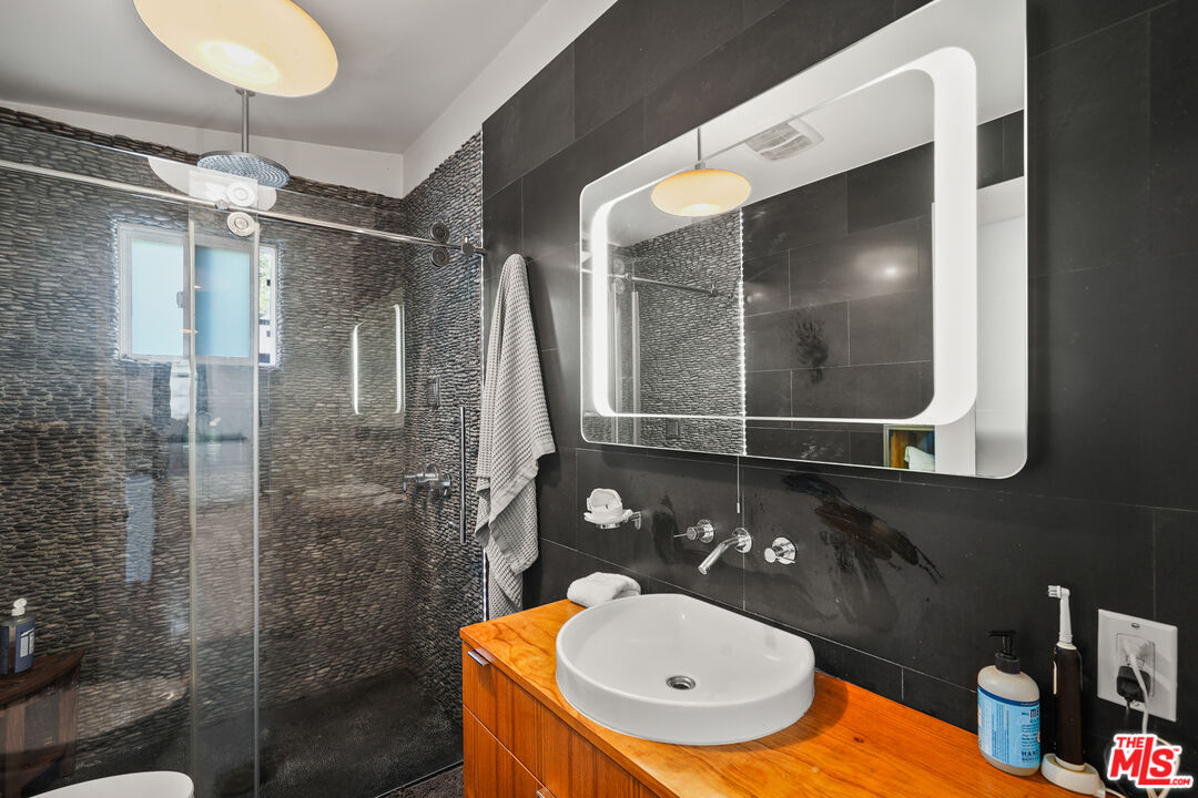 1240 Appleton Way Venice, CA 90291 - Photo 58 of 71 a bathroom with a sink mirror and a shower